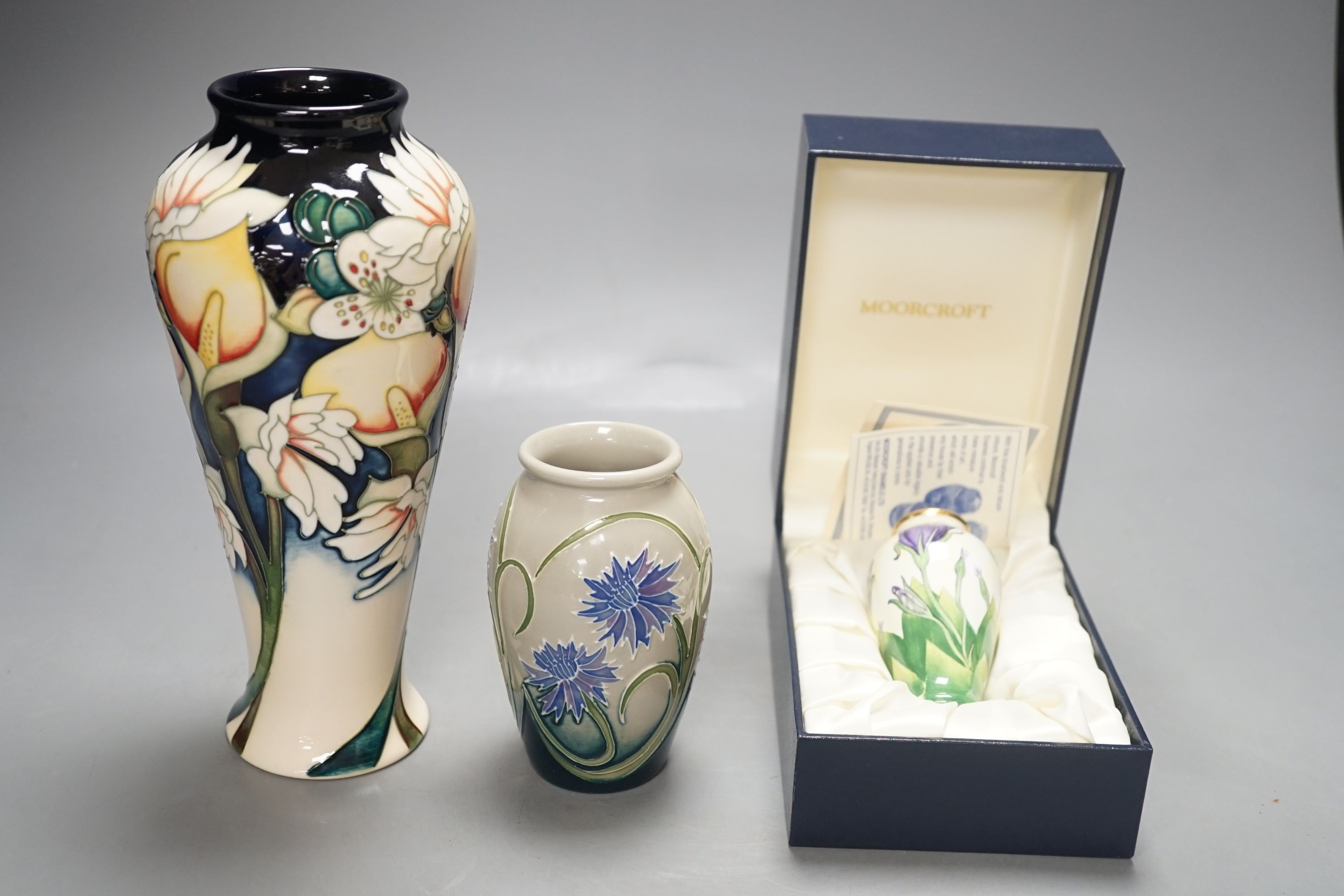 Moorcroft pottery vase, dated 2010, a smaller vase dated 2011 and a Moorcroft enamel Lisianthus vase, limited edition 93/100; signed J Hunne. All three boxed.